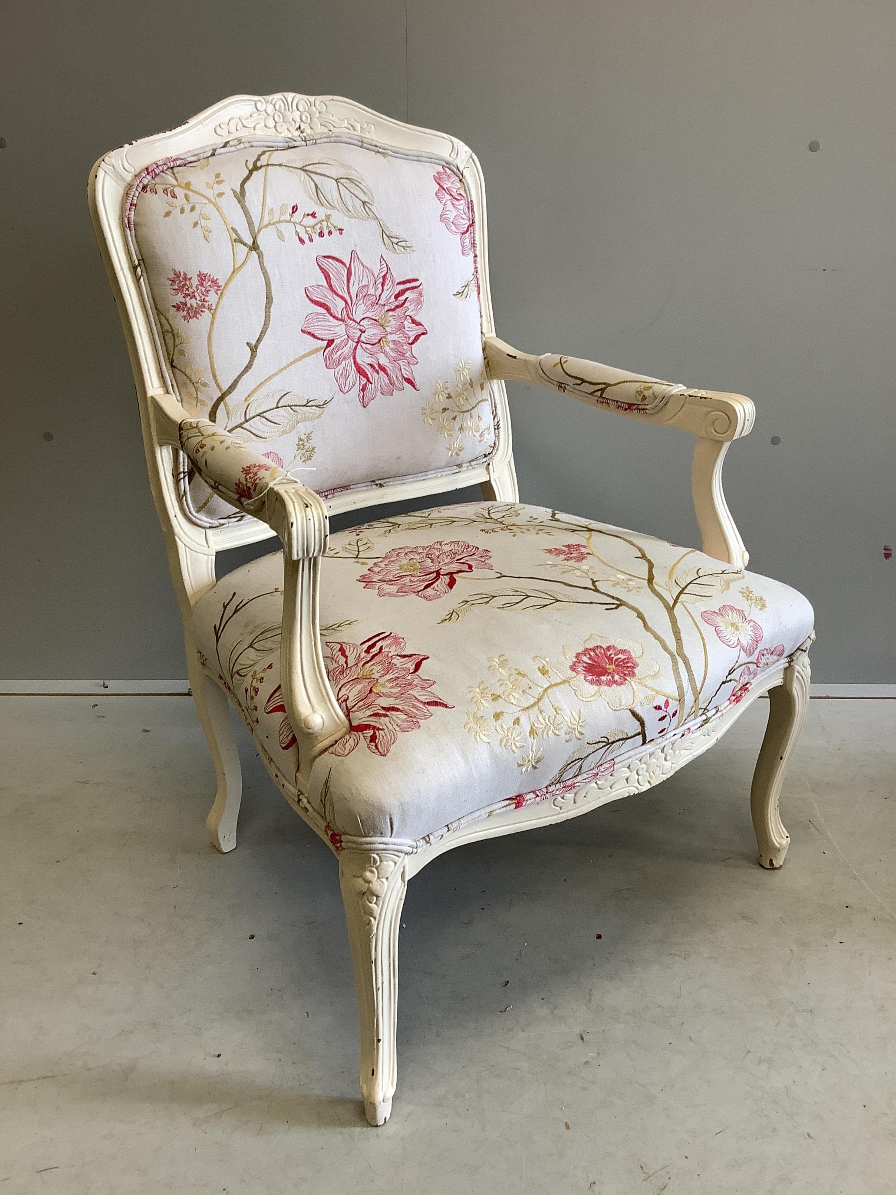 A Louis XVI style elbow chair and associated footstool upholstered in Voyage? fabric, chair width 65cm, depth 56cm, height 94cm. Condition - fair to good